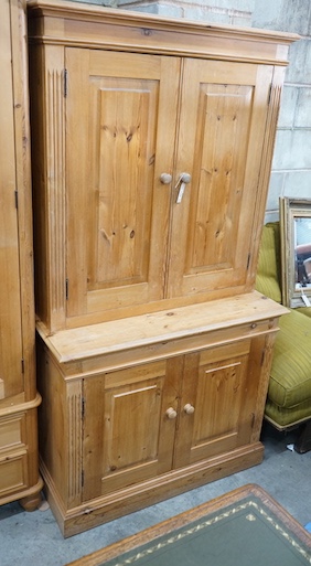 A modern pine dresser, enclosed by two pairs of fielded panelled doors, length 96cm, depth 45cm, height 178cm